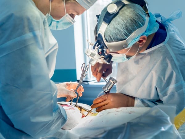 Doctors working on a minimally invasive spine surgical treatment.