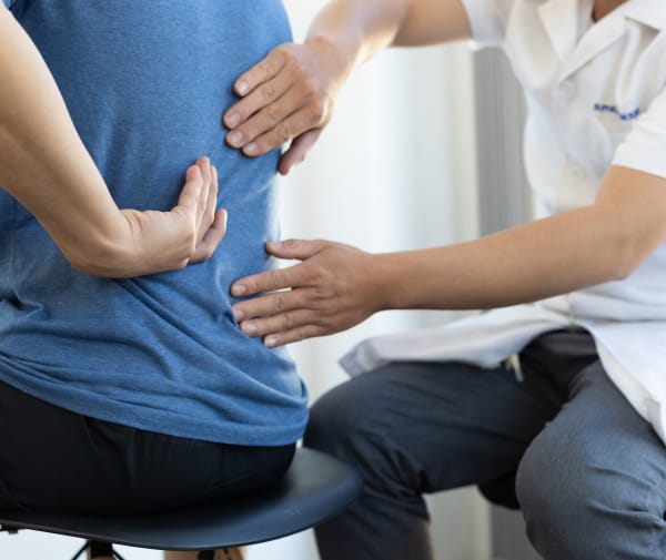 A man explains his back pain to the Doctor.