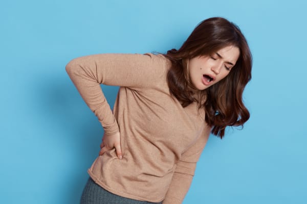 The image of a woman with severe low back pain.