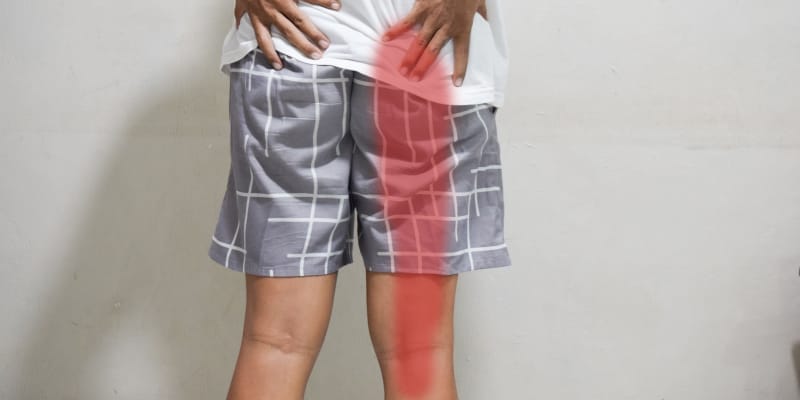 A man with sciatica leg pain, highlighting the painful area along the leg.